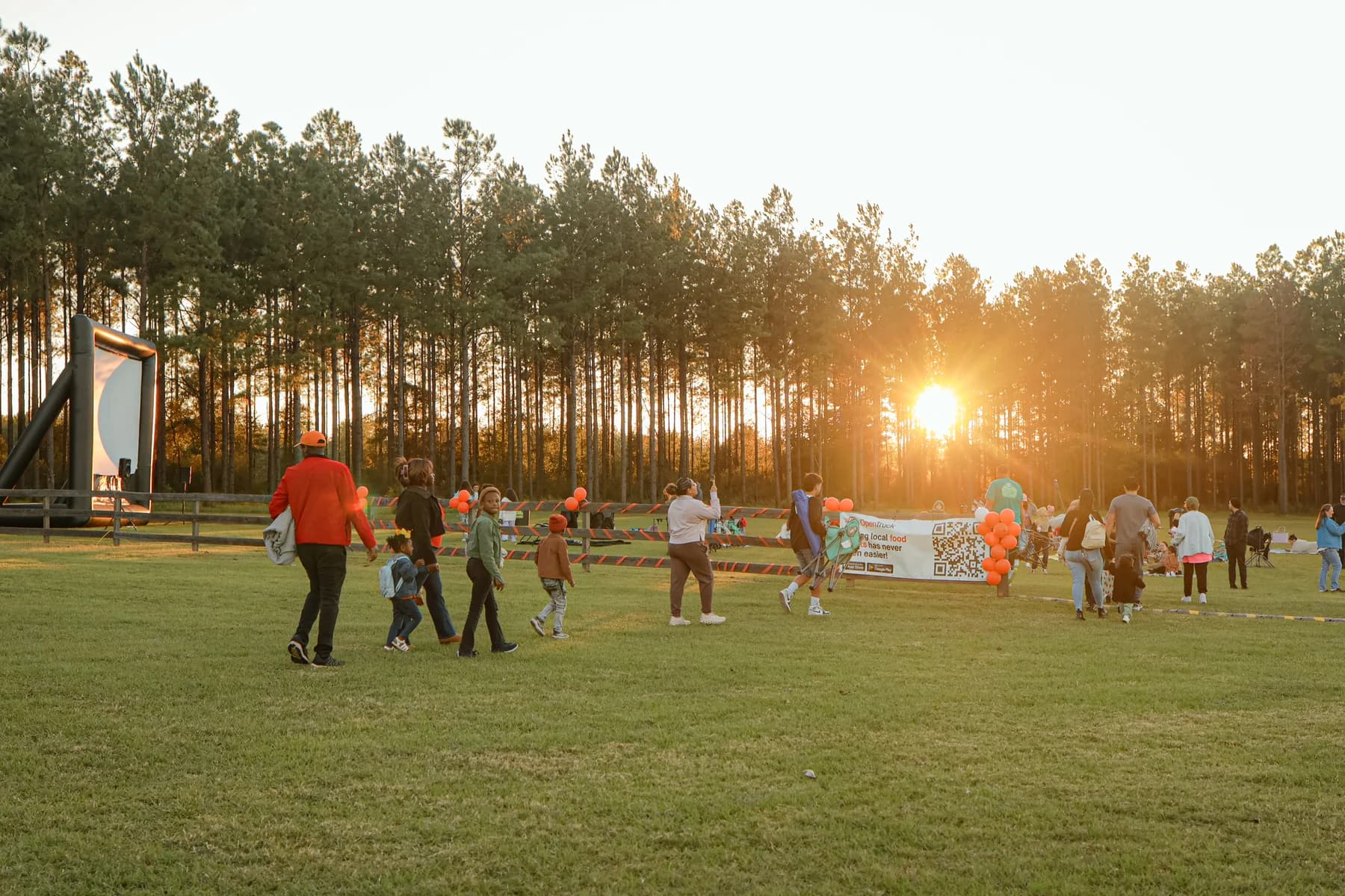 Families gathering for OpenTruck movie night at Loblolly Farm