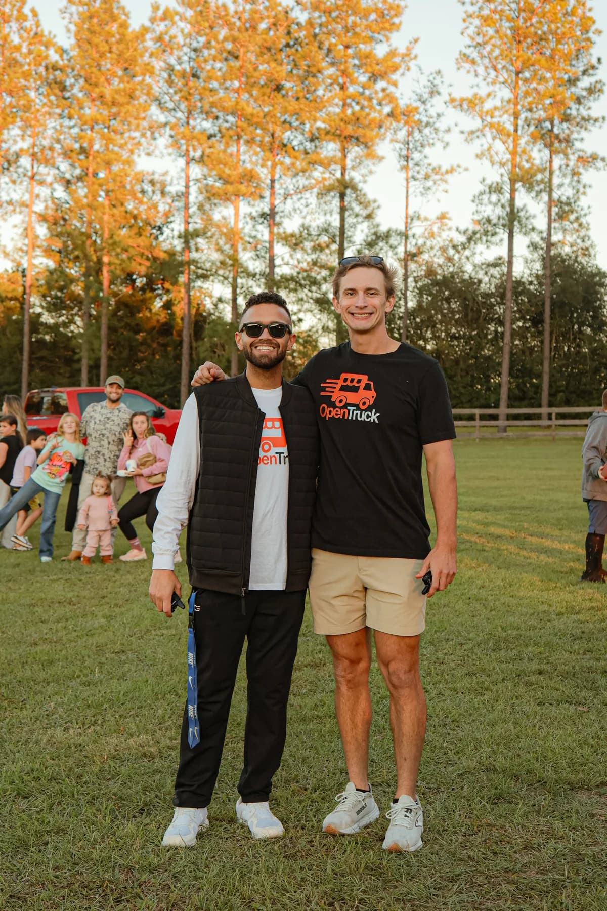 Two members of the OpenTruck community wearing branded shirts at family movie night